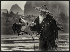 Cormorant Fisherman - Yangshuo, China. Black & White. B&W. Traditional clothing.
