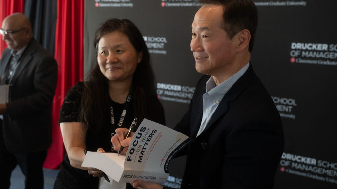 Steve Kim signing copies of Focus on What Matters following a presentation on business alignment and purpose-driven leadership.