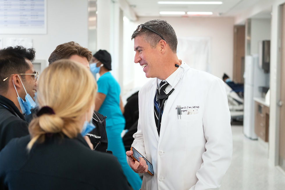 Dr. Carr having a discussion with junior staff members
