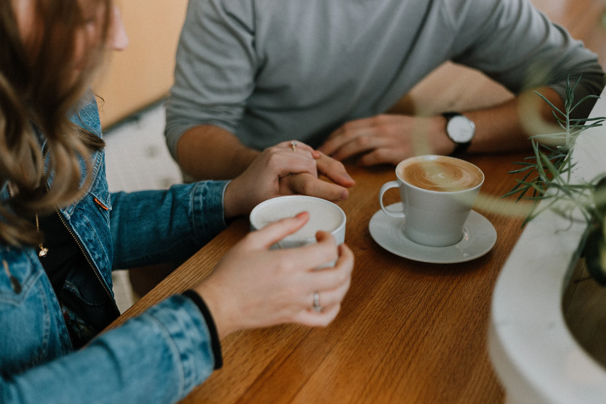 A couple on a date, each with a cup of coffee.