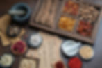 Chinese herbal medicine ingredients arranged in bowls and plates