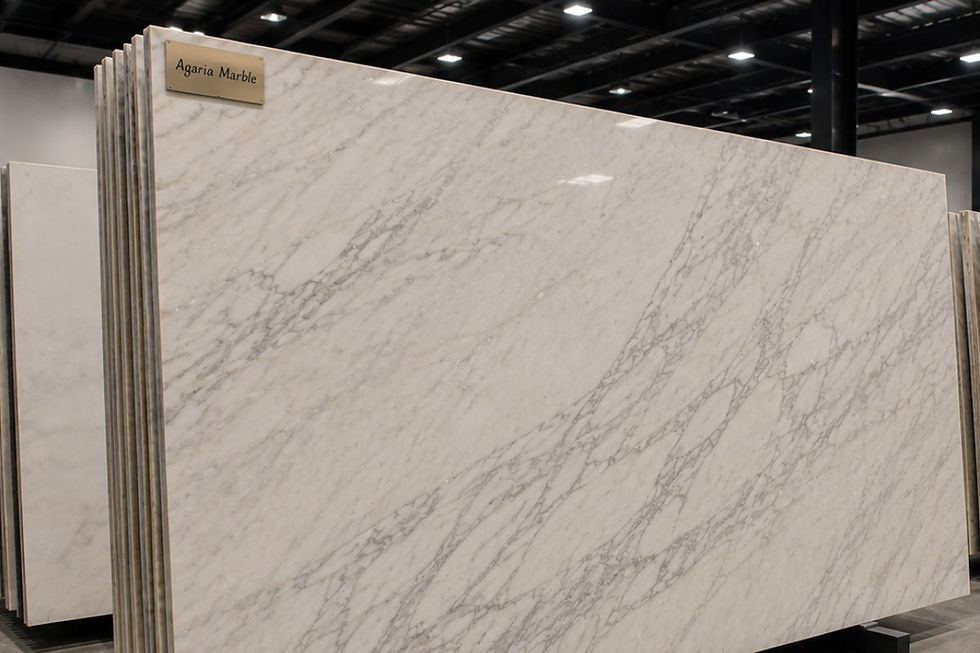 A large slab of white Agaria marble with soft gray lines.