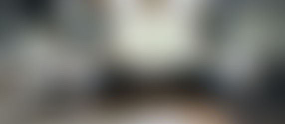 Elegant navy blue U Shaped Modular Kitchen with marble countertops, brass hardware, and farmhouse sink.