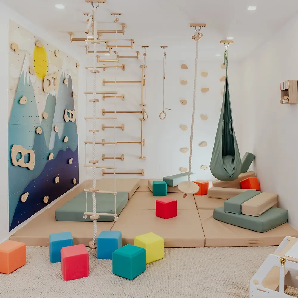 Modern playroom with climbing wall and soft mats for active play