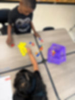 Students are working together to count how many shapes are in their pile. Students decided to sort between the different shapes then count.