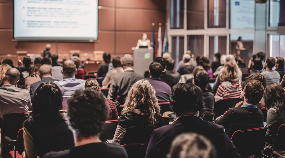 Professionals attending an industry conference and educational presentation