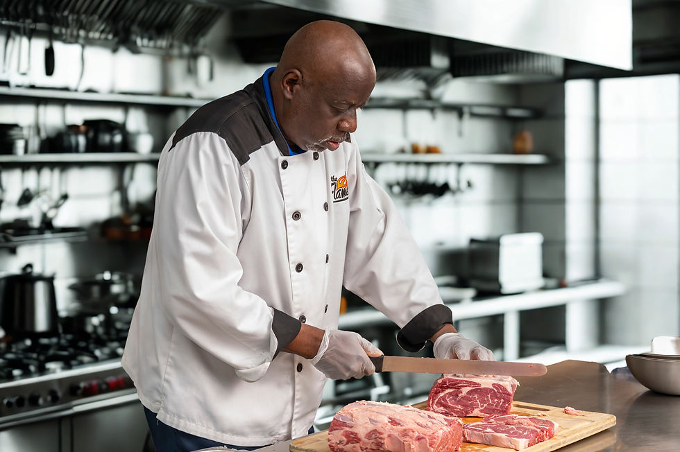 Chef Smoke Carving Steaks. The Flame Catering.