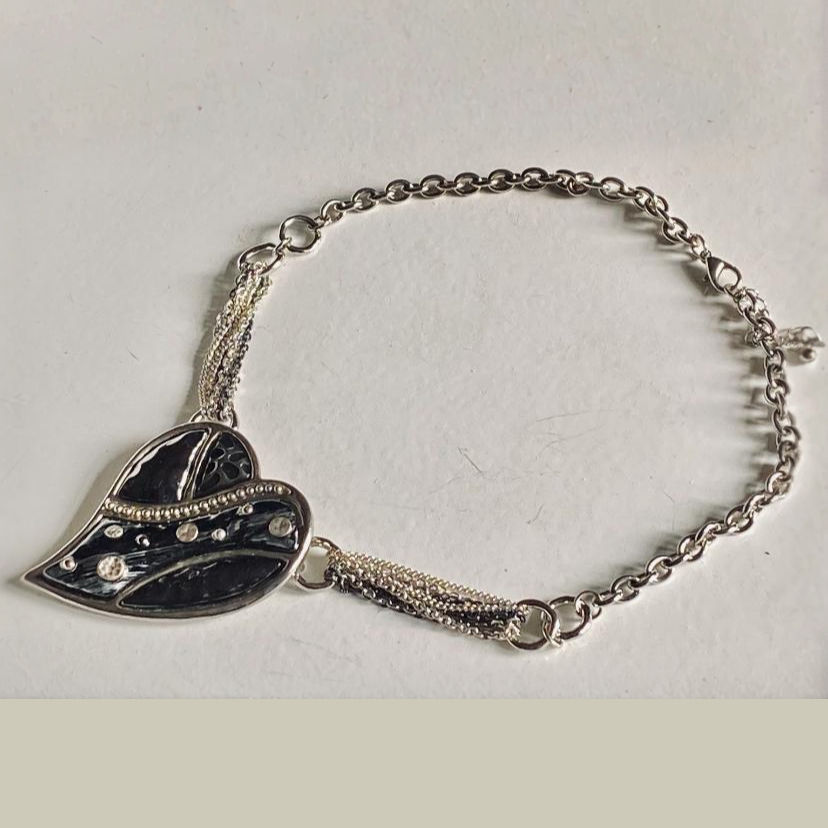 Silver heart-shaped bracelet with black enamel and clear stones; Timeless Jewellery.