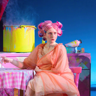 Theatre Lighting Programmer London a woman with pink hair is sitting at a table