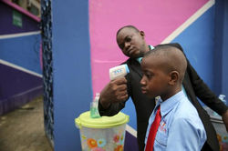 School Official  Takes Pupils Temperature At Private School In Lagos September 2