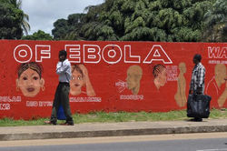 Pedestrians Walk Past Mural Showing Symptoms Of Ebola Virus In Monrovia Liberia 
