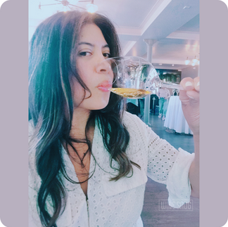 Ara Esparza for The Wine Snug sipping a glass of white wine