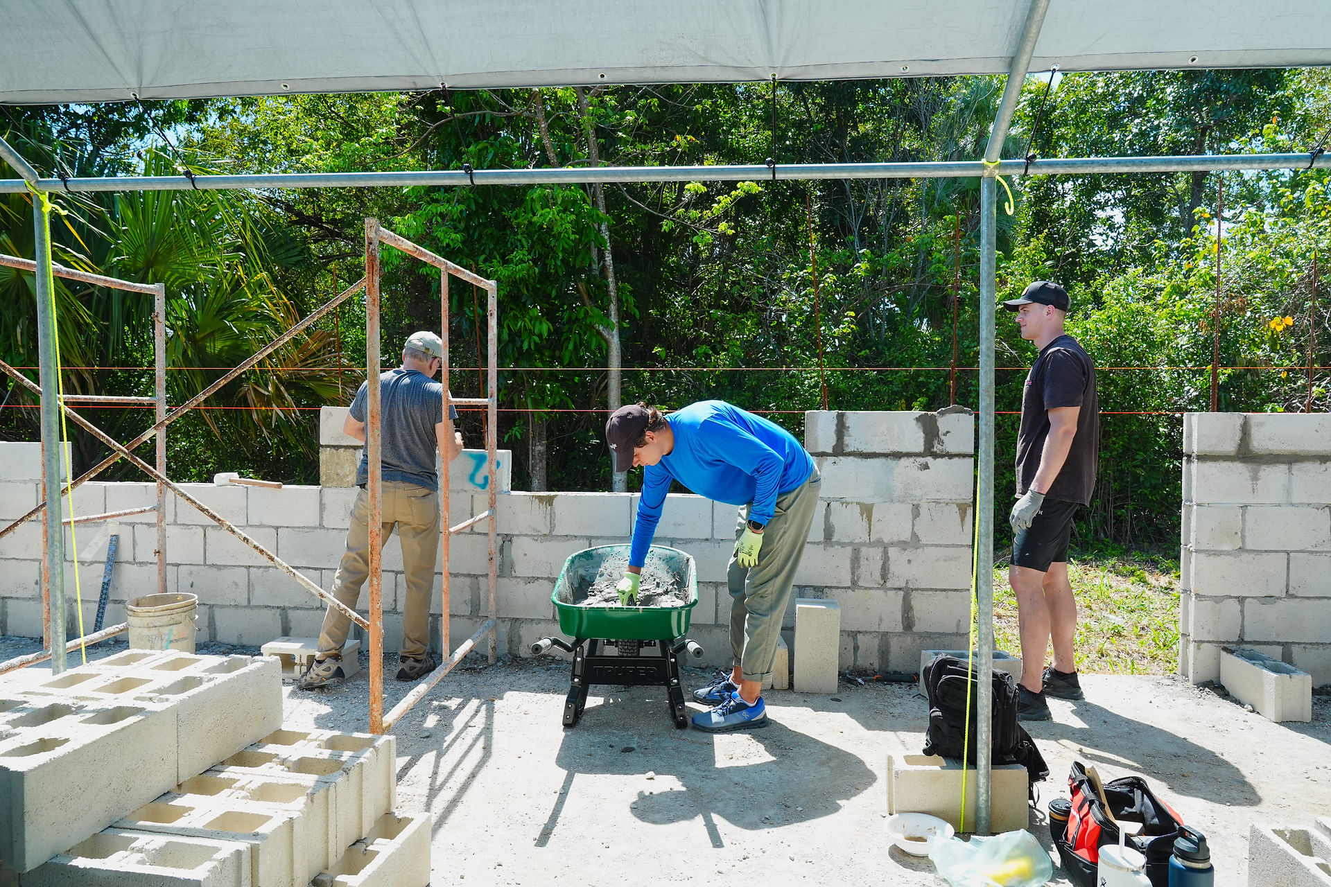 man working construction in tropical setting