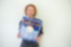 Virginie holding an Advent calendar during the Christmas season