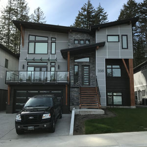 Architectural detail of a building featuring Easy Trim Reveals and Hardie Panel, showcasing a sleek and modern design with precise trim work that highlights the clean lines and robust texture of the panels for a contemporary exterior finish.