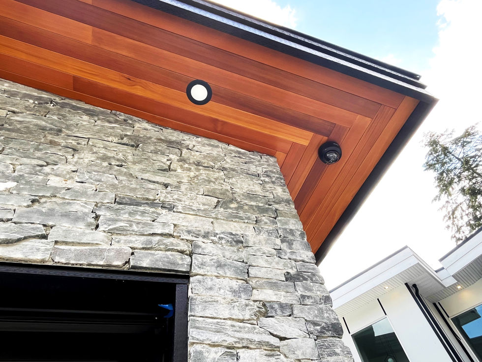 Elegant natural wood soffit installed under the eaves of a home, adding a touch of timeless beauty and providing durability and improved airflow. The warm, inviting texture complements the home's exterior, blending functionality with architectural charm.