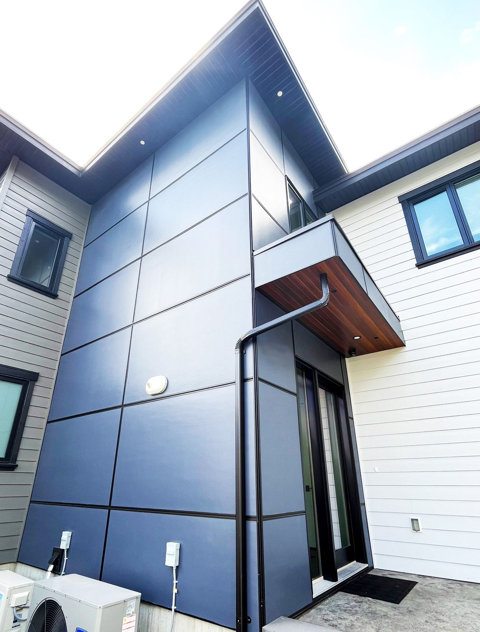 Contemporary home featuring Easy Trim Reveals, Hardie Panel, and Hardie Plank siding, showcasing a sleek and modern exterior