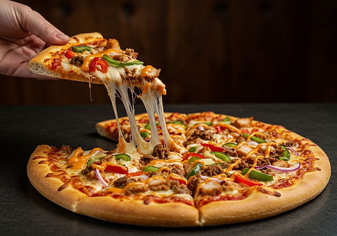 Hand lifting a slice of hot pizza with delicious melting mozzarella cheese pull, close-up 