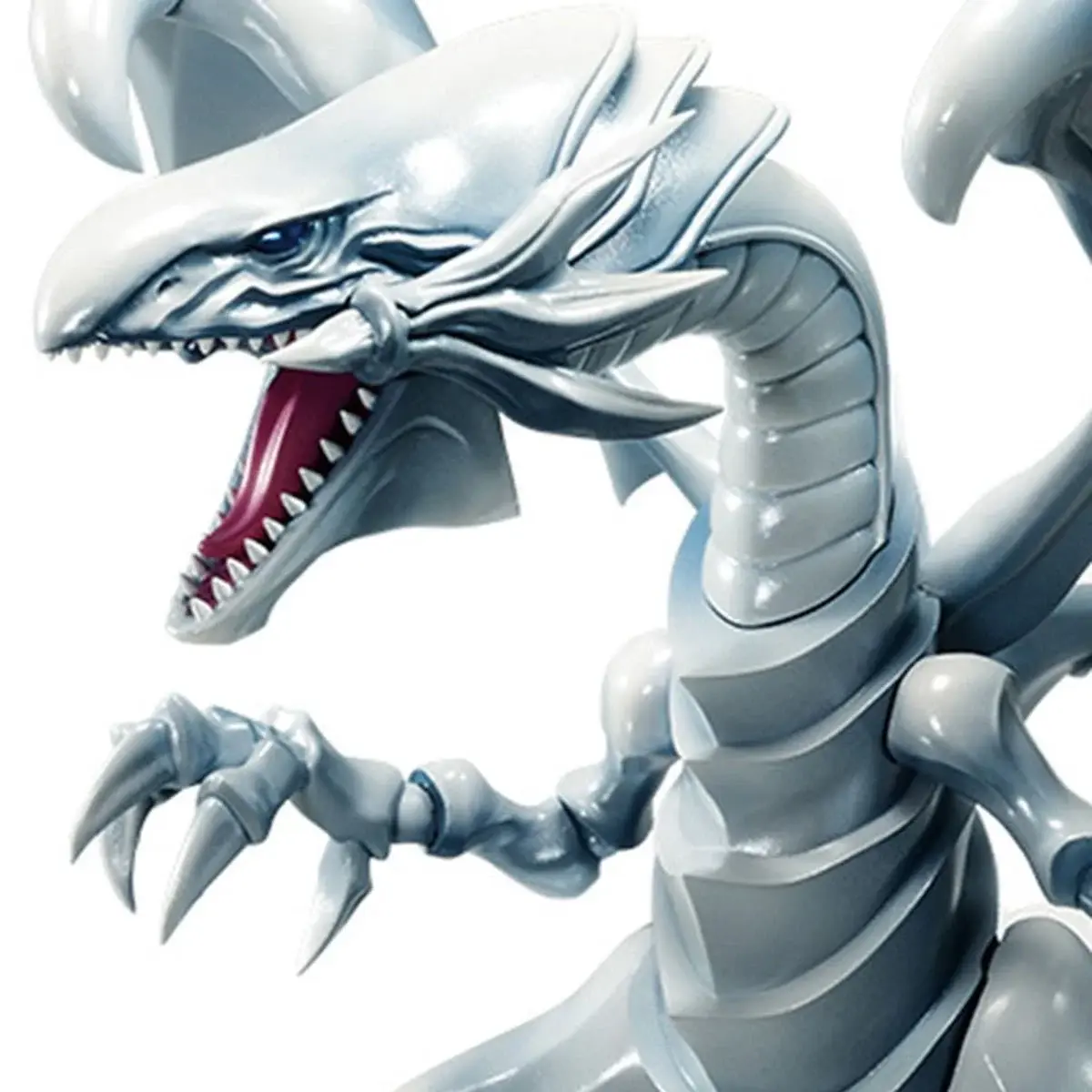 White sculpture of a dragon with sharp teeth and open mouth