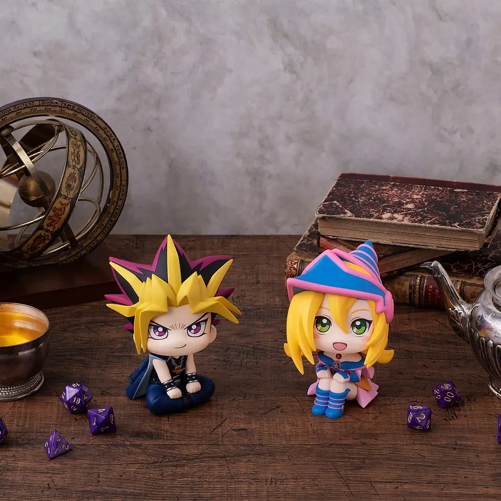 Thumbnail: Yugi Muto and Dark Magician Girl figurines on a wooden table with books