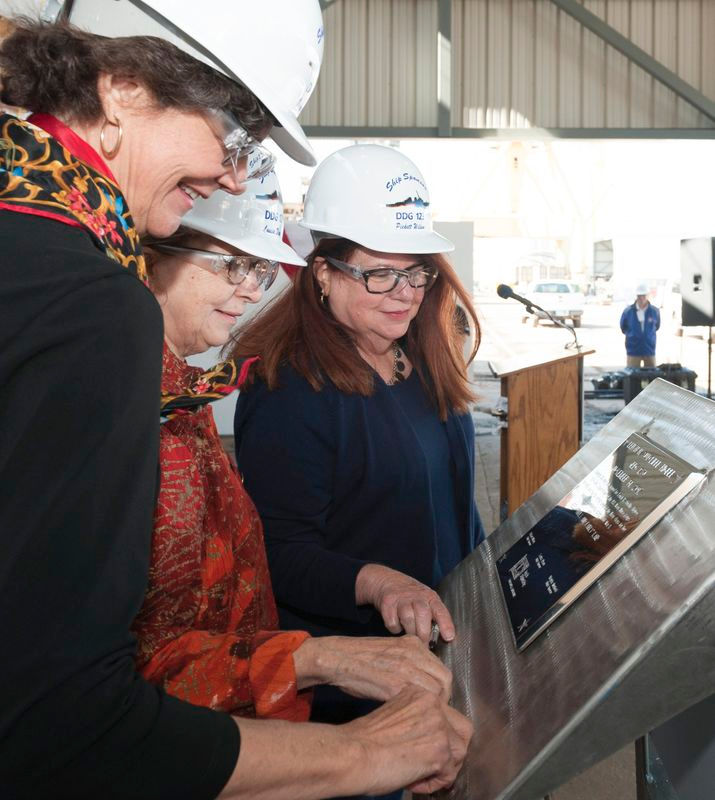 Ship’s Sponsors (left to right) Virginia Munford, Louisa Dixon and Pickett Wilson trace their initials onto a steel plate that will be welded inside the guided missile destroyer Lenah H. Sutcliffe Higbee (DDG 123). Photo by Michael Duhe/HII