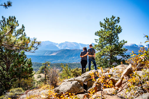a couple looking at the mountain view in colorado