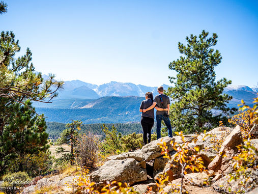 a couple looking at the mountain view in colorado