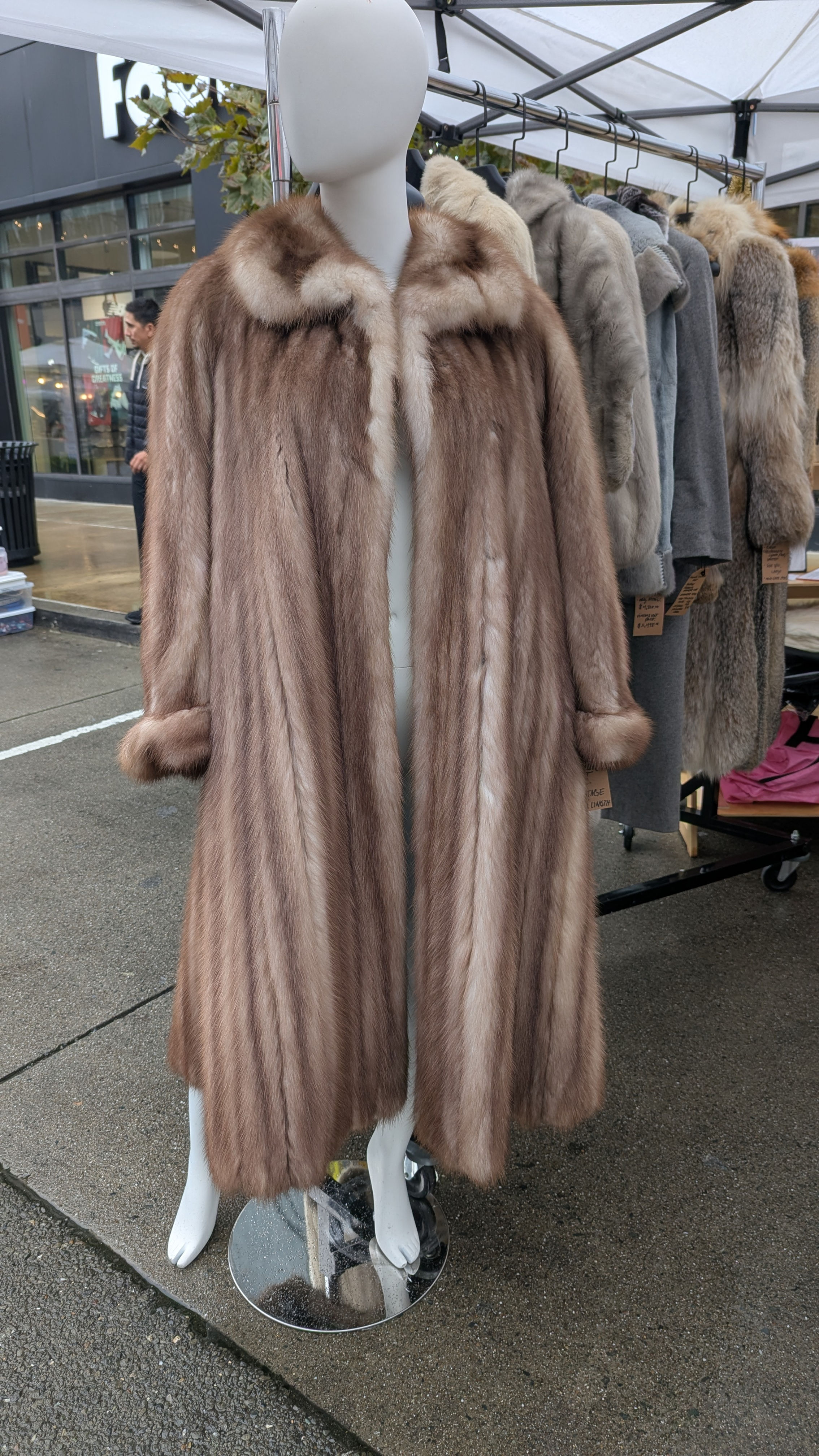 Full length vintage stone marten fur coat displayed on mannequin, natural brown luxury fur with floor length silhouette