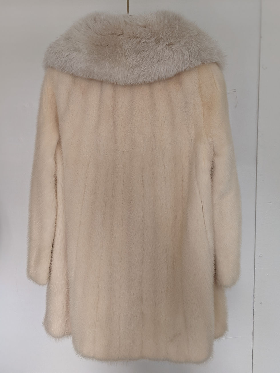 Миниатюра: blonde mink coat hanging in natural daylight
