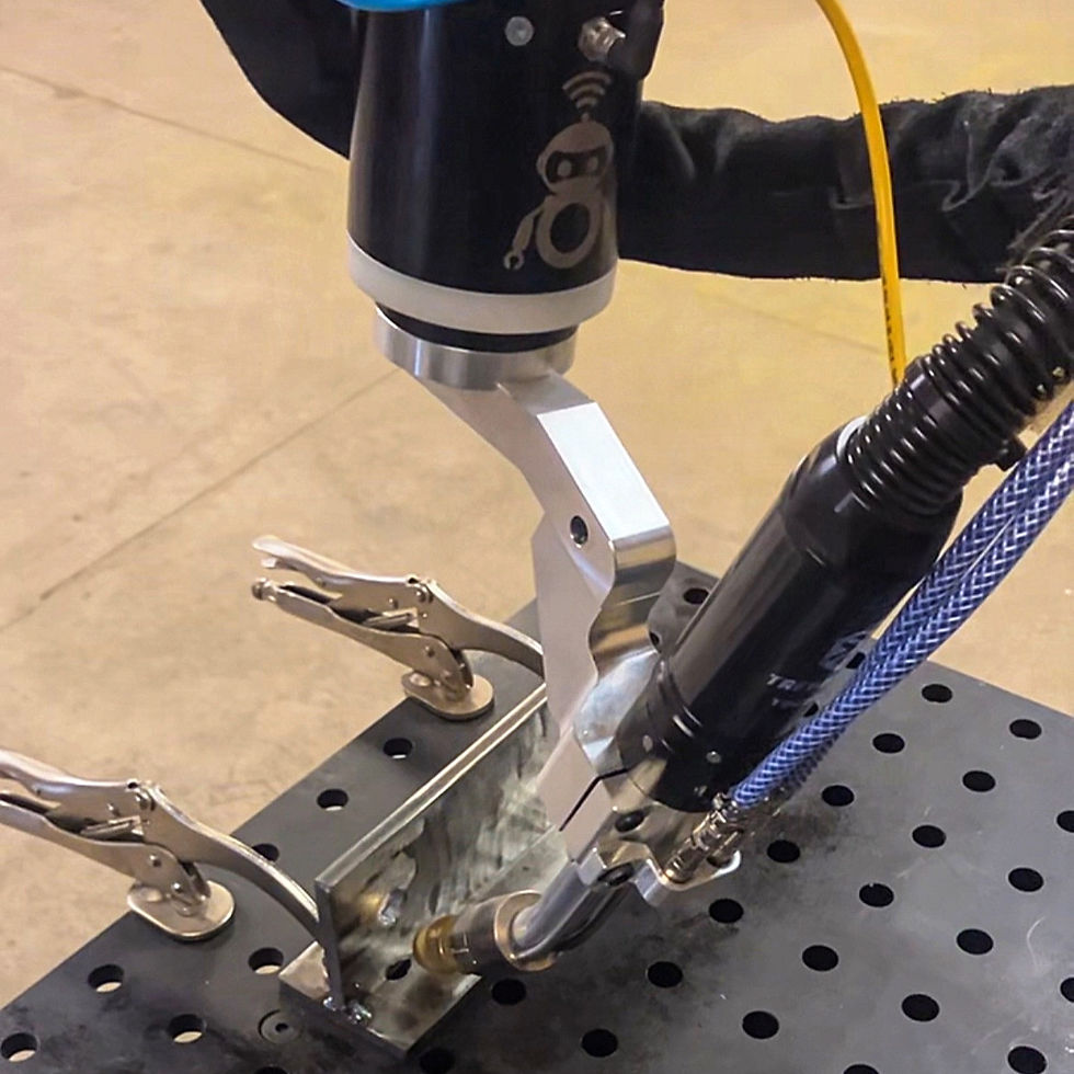 A cobot welder welding a part