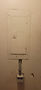 CRITEC whole house surge protector mounted below a breaker panel