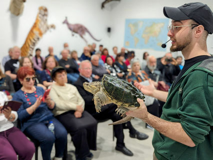Seniors Group Tours watching a wildlife presentation with a turtle