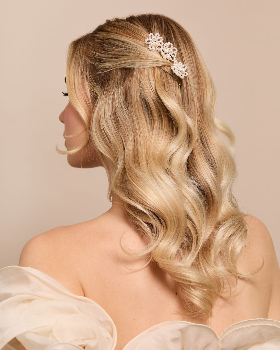 Soft romantic bridal hairstyle with loose texture and elegant face framing pieces