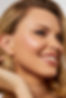 Blonde bride smiling with glowing, radiant wedding makeup which has been applied in a soft but glamorous way.