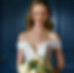 A bride in a central London Hotel beaming with joy after seeing her wedding hair softly waved, and her bridal makeup looking flawless.