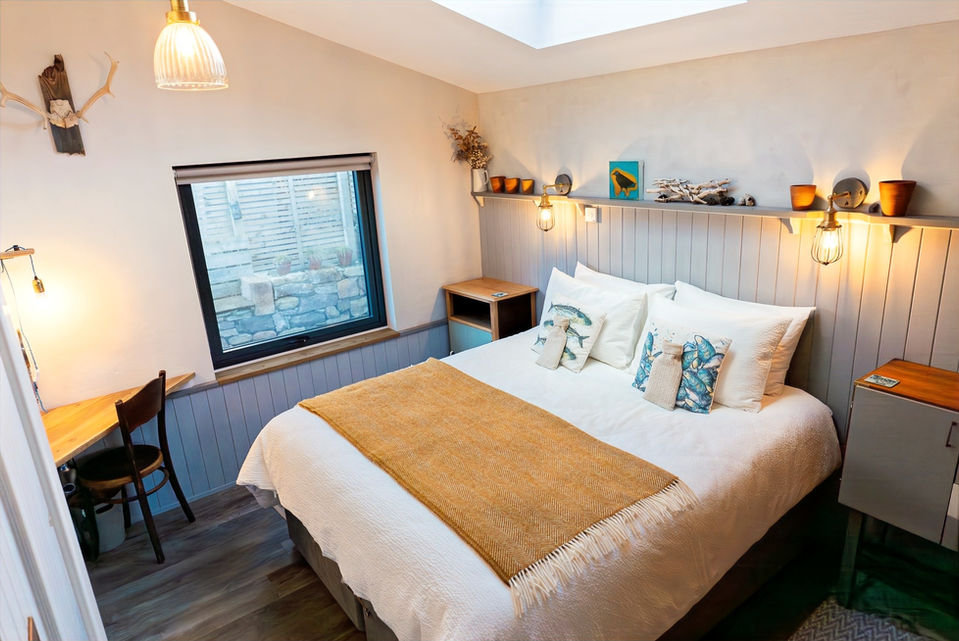 high angle of the bedroom. view through the window to the outside seating area