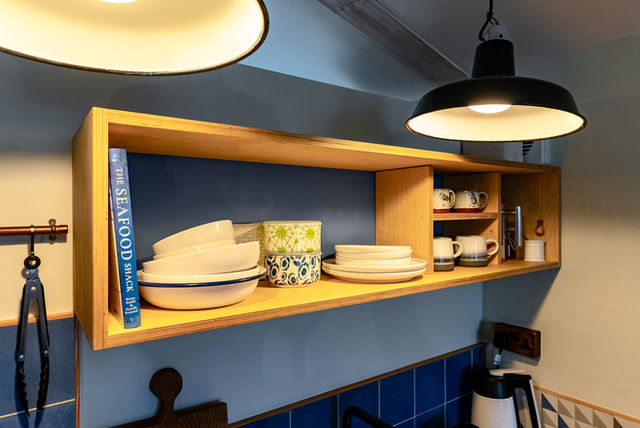 the crockery and cook book shelf above the kitchen