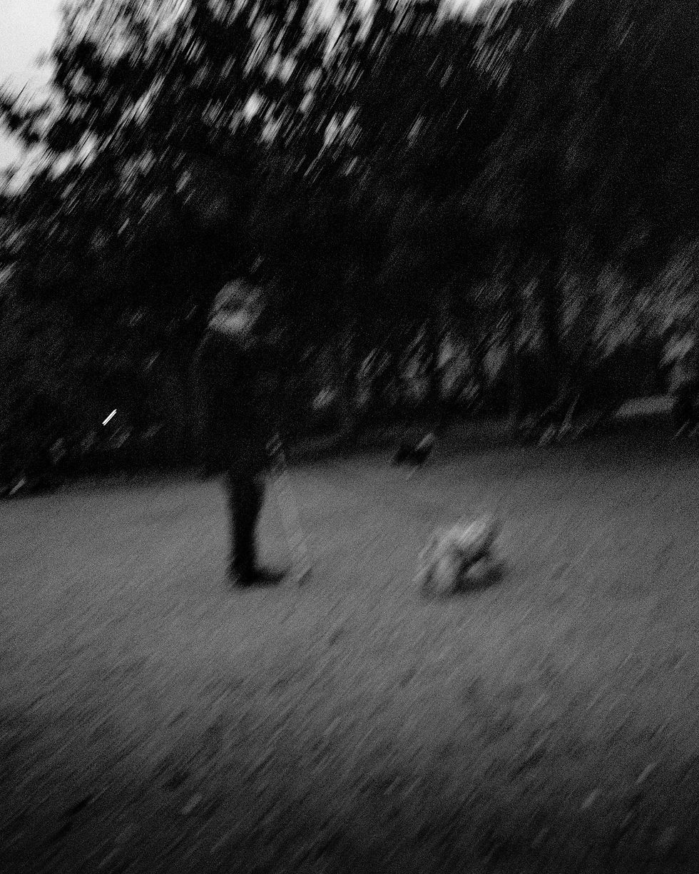 Blurry photo of a man outside the Grand Palais Éphémère. Alexander Eveleigh Photography.