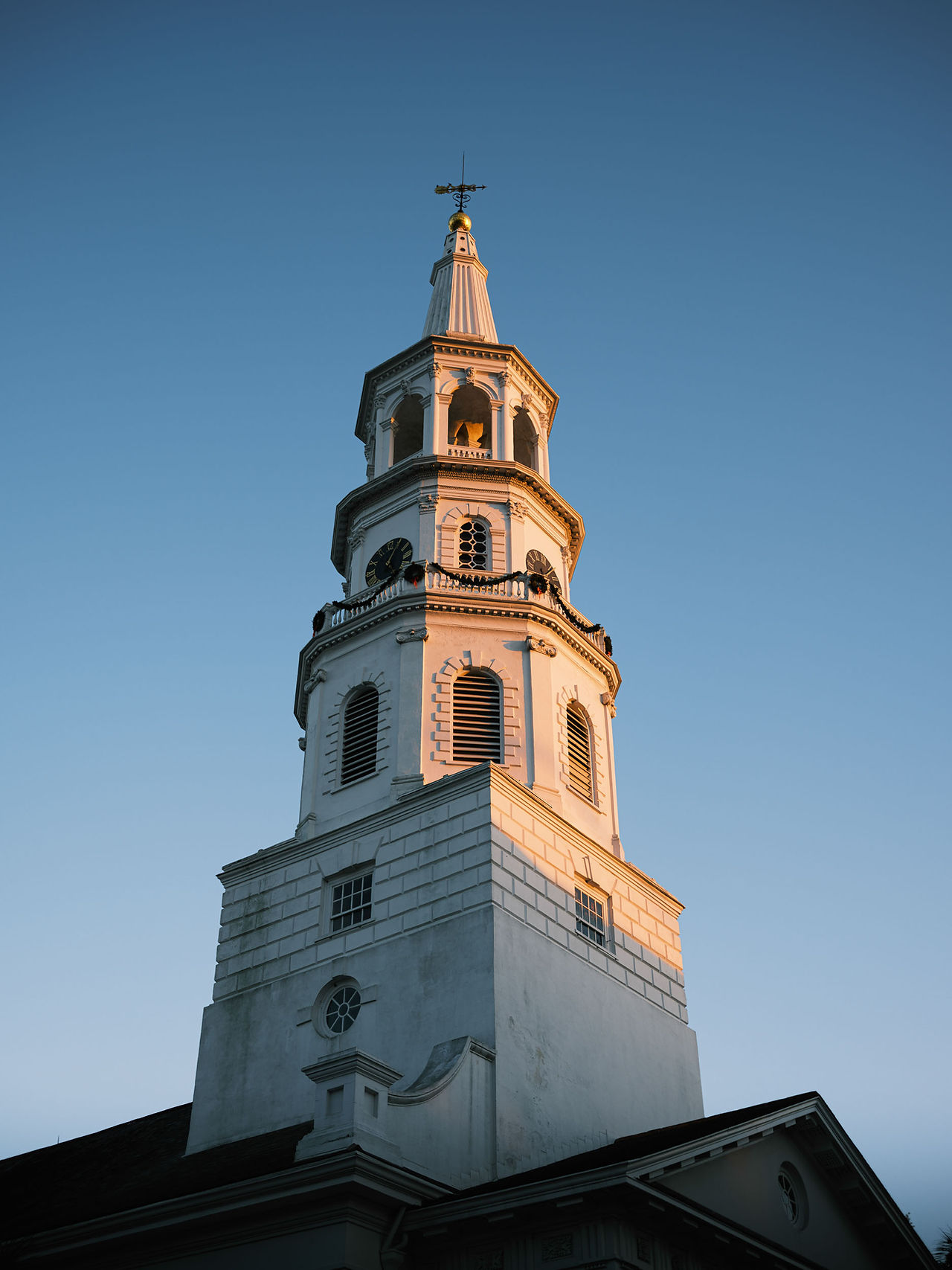 Charleston white church spire during golden hour.