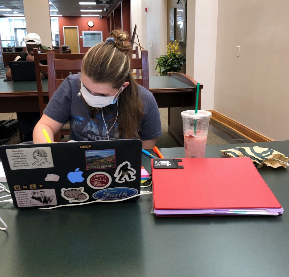 Freshman Carrie Hawes-Sanders taking notes in the Mary Livermore Library.
