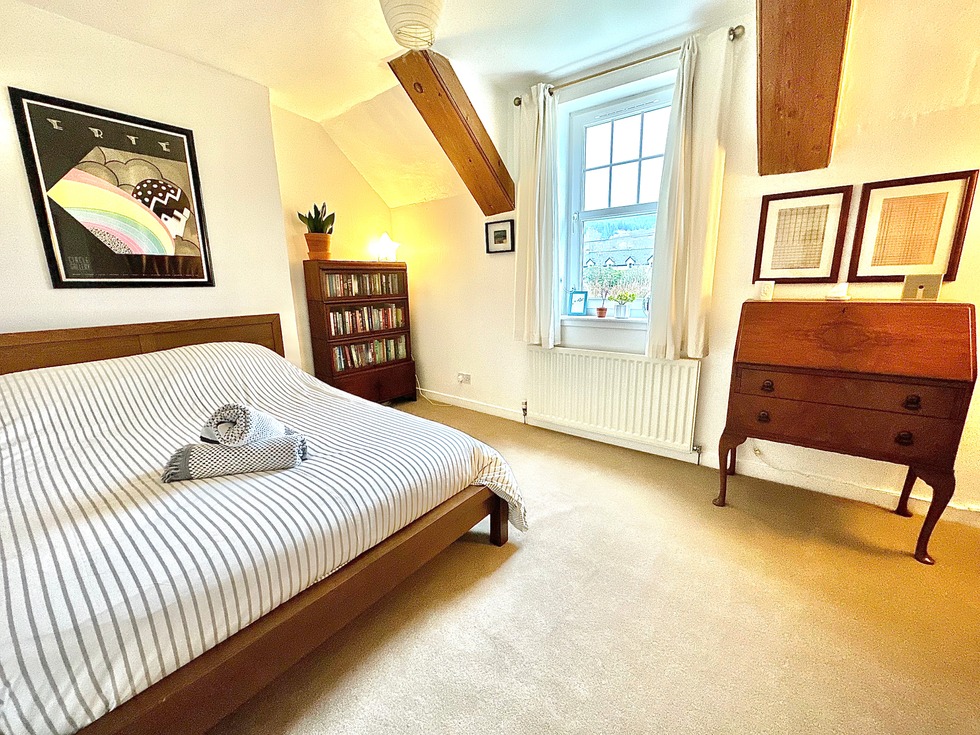 Bedroom neutrally decorated with wooden furniture