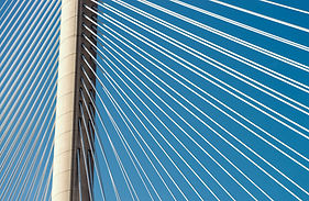 Bridge connecting two points across water, representing market access and cross-border movement