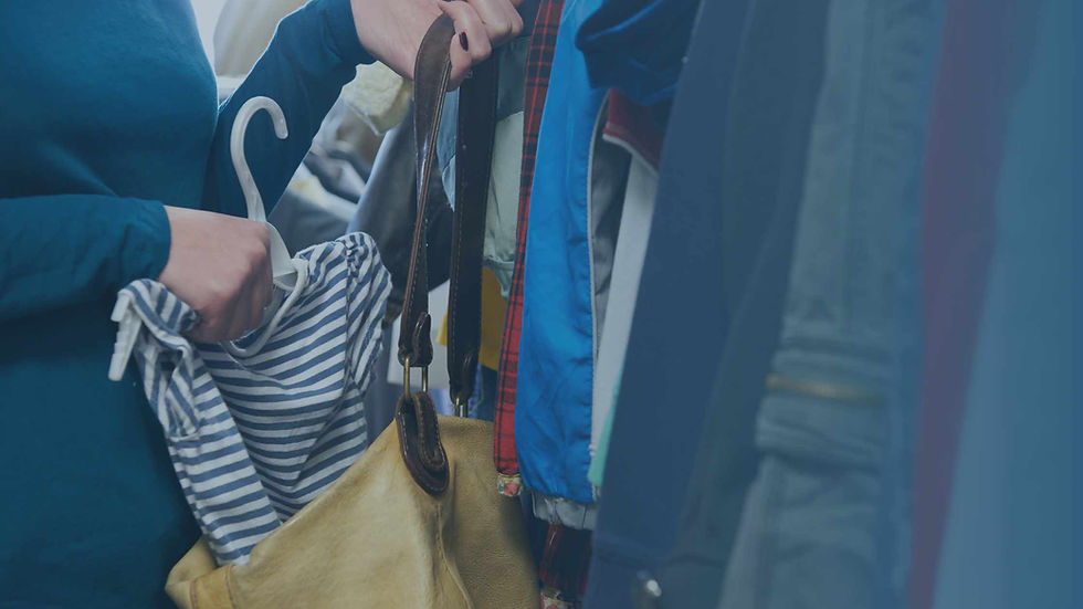 woman shoplifting by placing a shirt in her purse