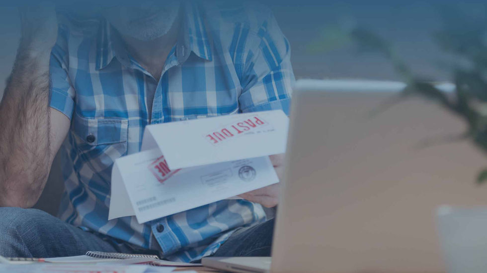 man looking at past due bills considering filing bankruptcy