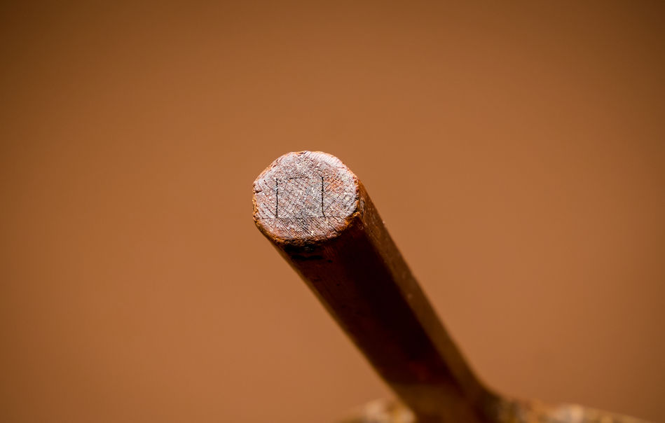 Butt end of an antque tennis racquet