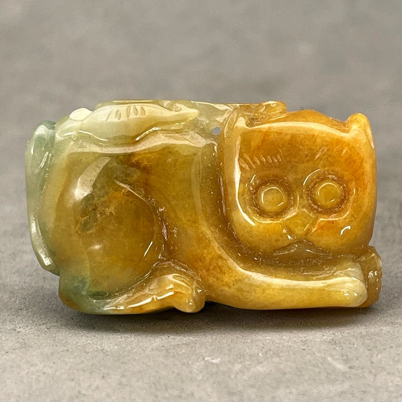 Vintage Hand carved Jadeite pendant of a cat, seated cat, green and honey