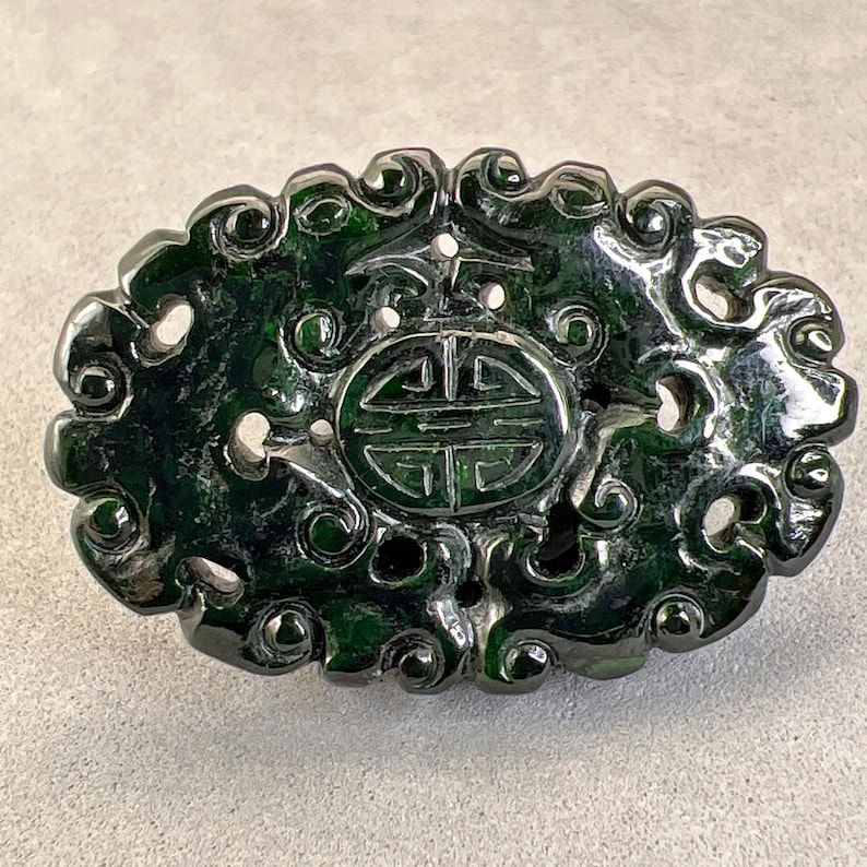 Jadeite carving: dark spinach jade charm, carved with longevity symbol