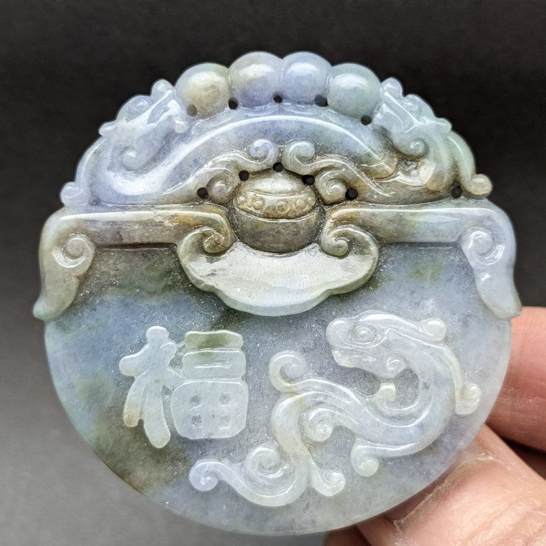 Hand carved jade pendant: dragon and its flaming pearl, a symbol of