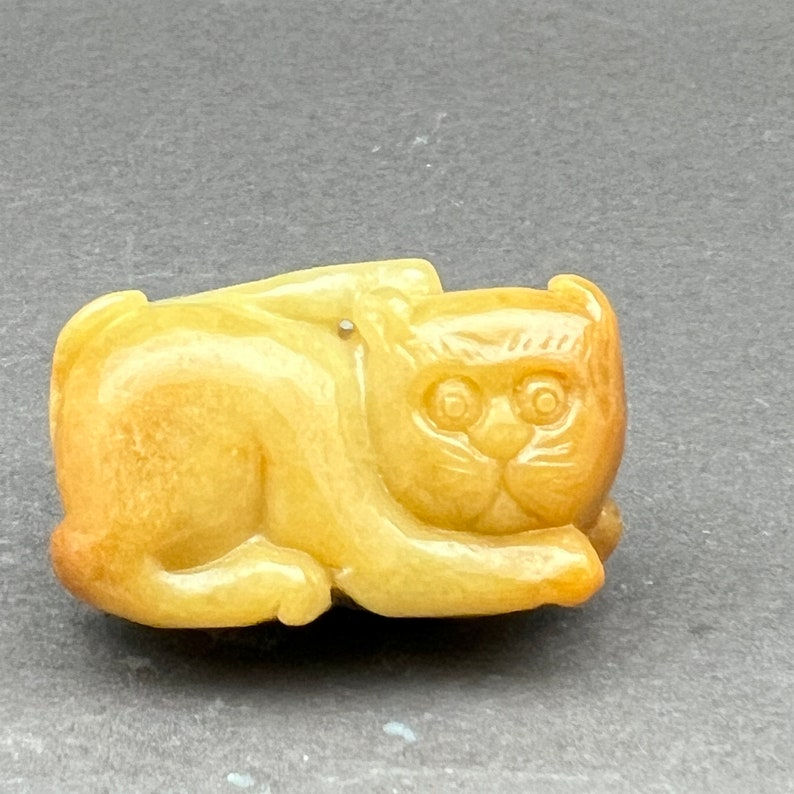 Vintage Hand carved Jadeite pendant of a cat, seated cat, green and honey