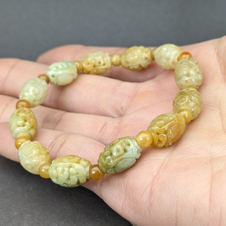 Jade bracelet: 12 oval shape translucent honey jadeite bead bracelet, dragon
